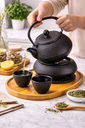 Cast iron teapot set (1.2L teapot, 4 cups, 1 teapot mat, 1 round stove) Black /طقم إبريق شاي من الحديد الزهر (إبريق سعة 1.2 لتر، 4 أكواب، حصيرة إبريق شاي، موقد دائري) أسود